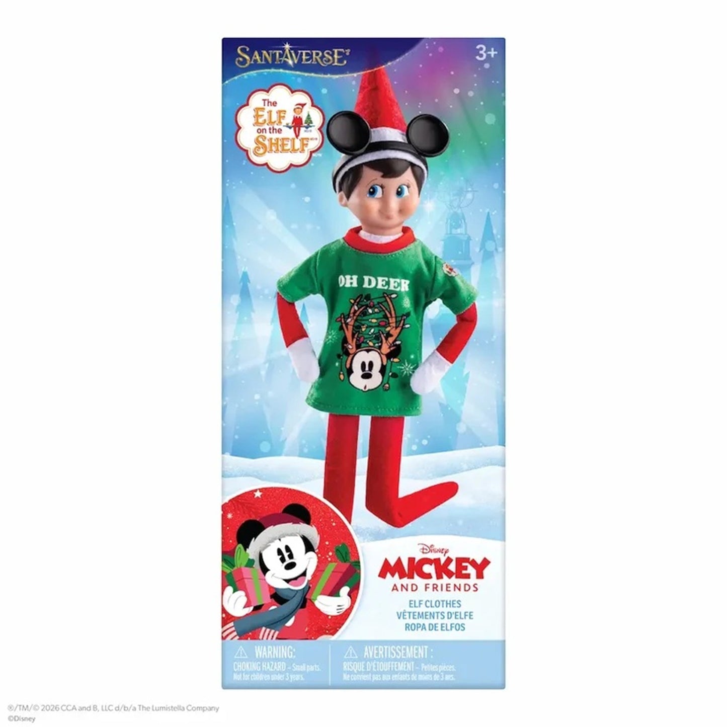 The Elf on the Shelf Mickey and Friends Christmas Elf Clothing set in its retail packaging, featuring a doll dressed in a green shirt, red pants, and a Santa hat.