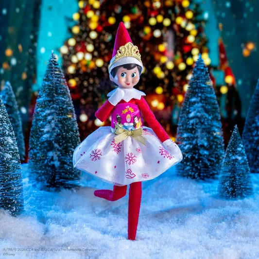 Elf on the Shelf doll in a festive setting with Christmas trees and lights.