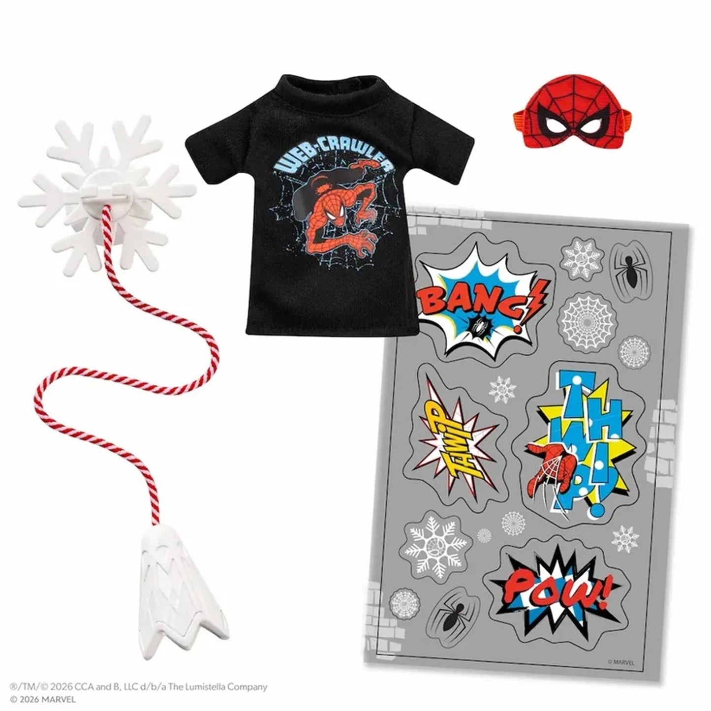 A Spider-Man themed doll accessory set featuring a black t-shirt with a red and blue graphic, a red and blue spider mask, a white snowflake toy with a red-and-white rope, and a gray sticker sheet with comic-style impact graphics.
