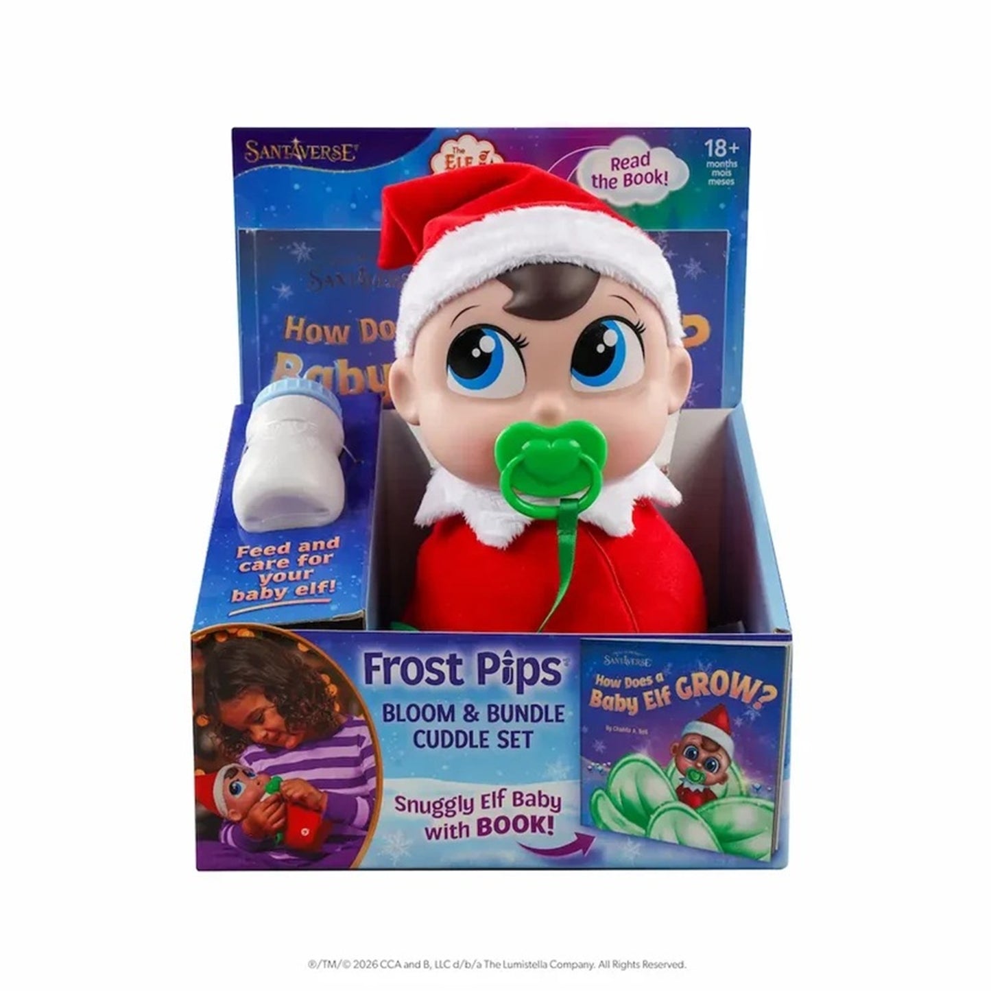 Frost Pips Bloom & Bundle Cuddle Set by Sanverse, featuring a baby doll dressed as a baby elf with a red Santa hat, red outfit, green pacifier, and a white bottle, presented in its retail packaging.