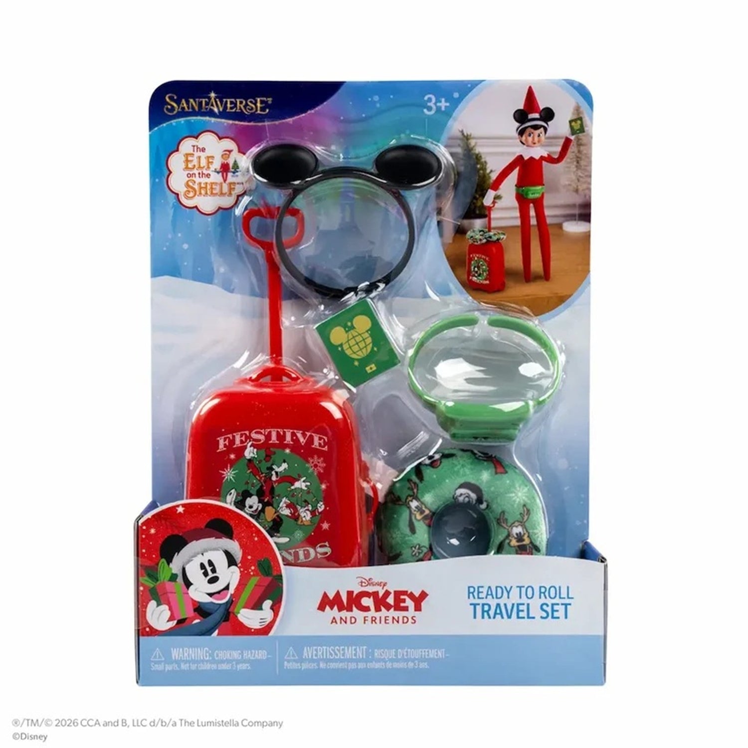 Disney Mickey and Friends SantaVerse Elf on a Shelf Ready to Roll Travel Set in its original blister packaging, featuring a red suitcase, black Mickey-style ears, a green hat, and a green scarf.