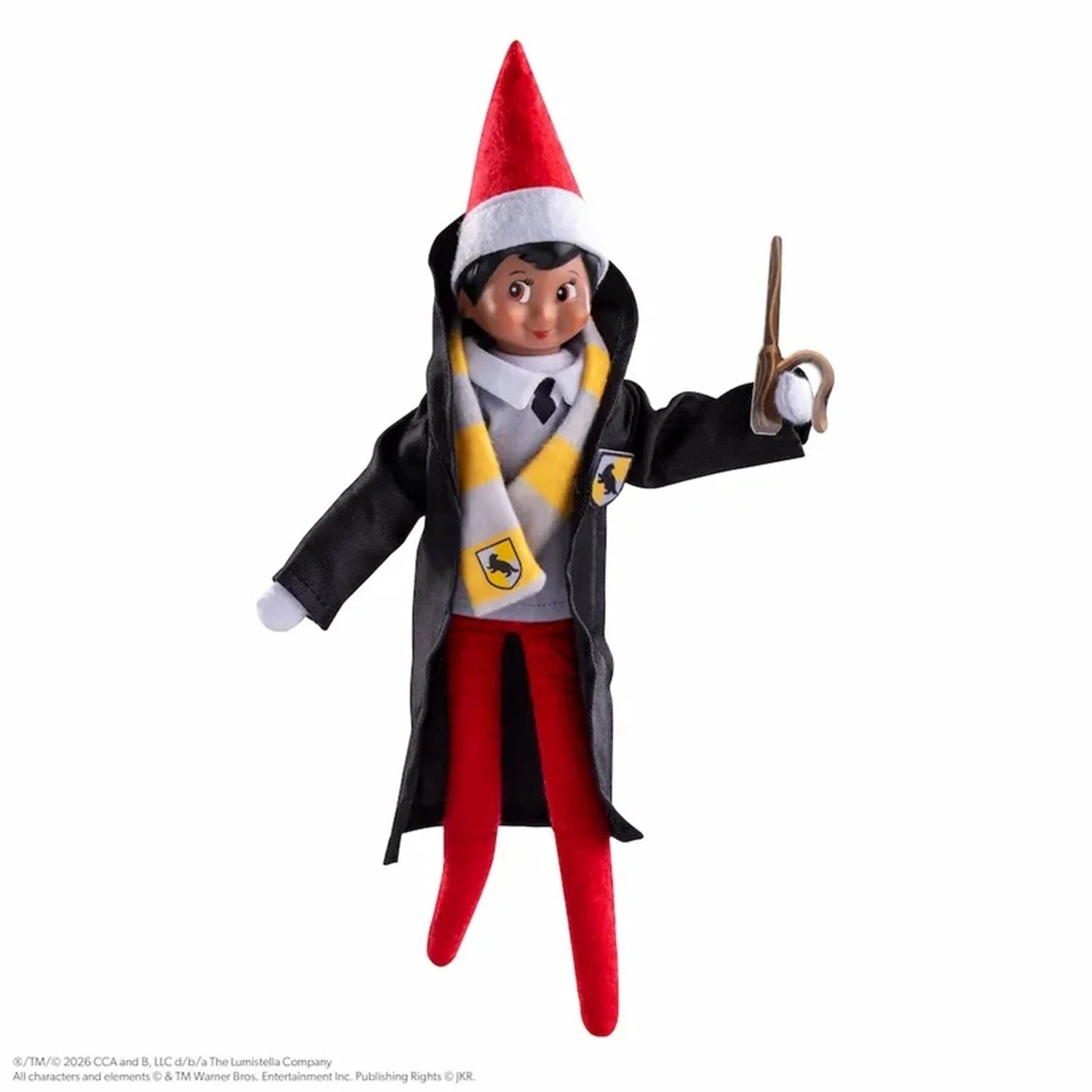 A plush elf doll dressed as a wizard, wearing a black robe, red hat, red pants, and a yellow-and-white scarf, posed against a plain white background while holding a wand.