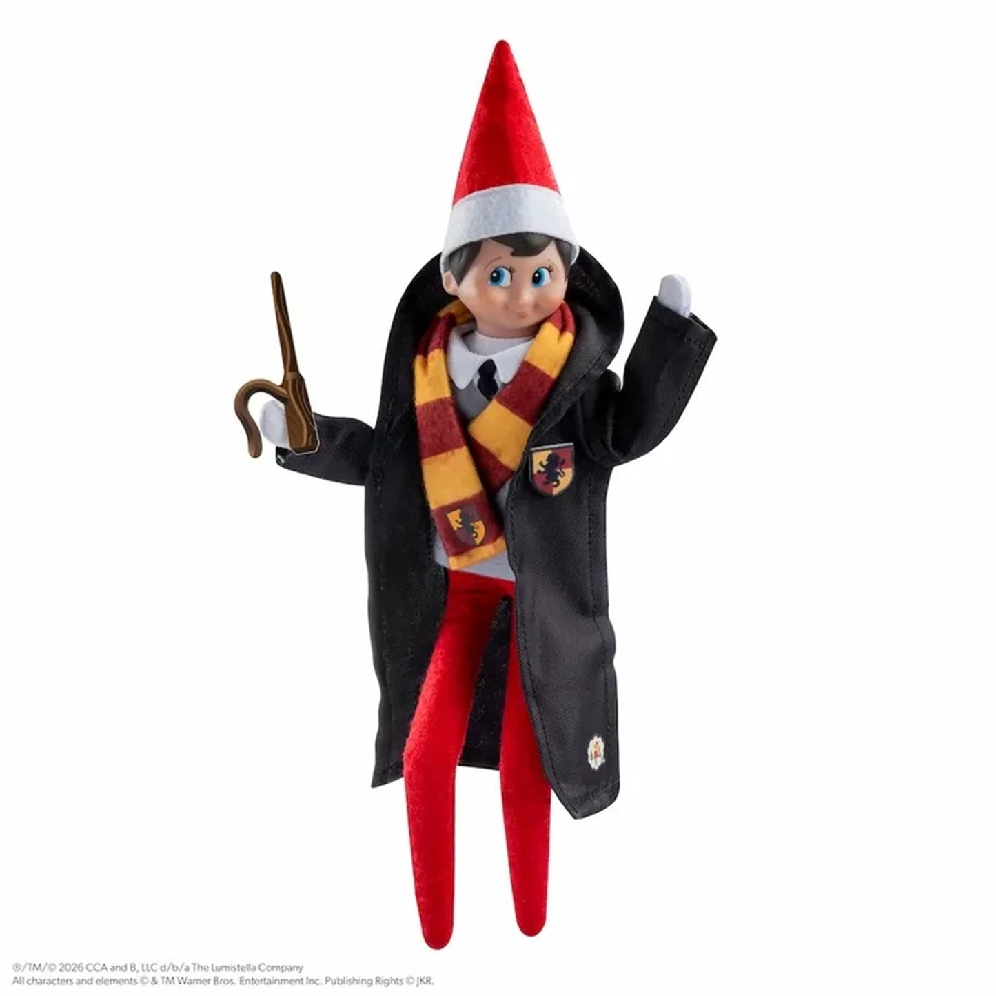 A plush elf doll dressed in a Hogwarts-inspired outfit, including a red and white pointed hat, a red and gold striped scarf, a black coat, white shirt, and red pants, holding a brown wand against a plain white background.