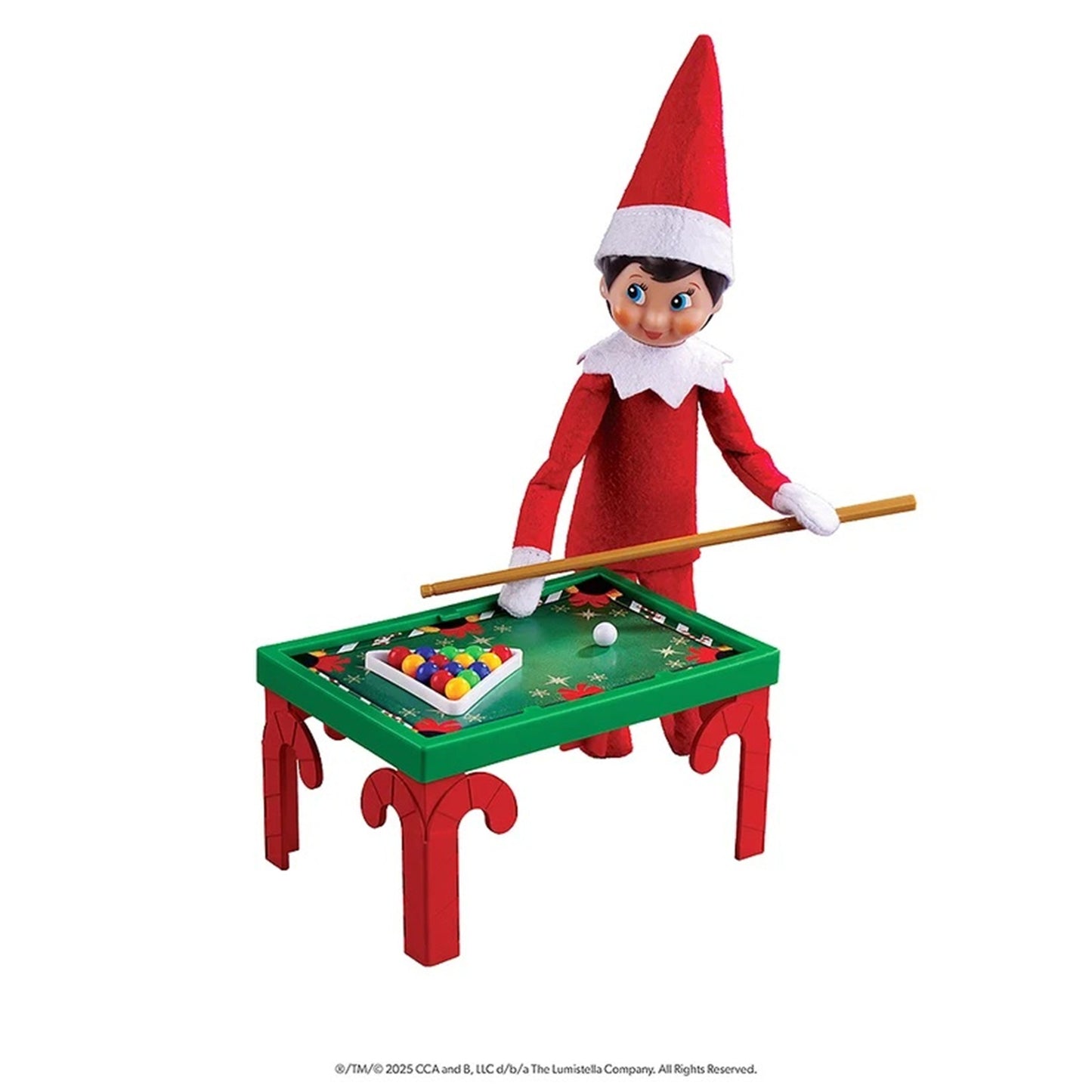 Elf on the Shelf toy figurine wearing a red suit and hat, holding a wooden pool cue over a small green and red billiards table with a triangle rack of colorful balls, on a white background.